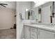 A gray bathroom is well-appointed with double sinks, a stone countertop, and modern fixtures at 7095 Falabella Ridge Ave, Las Vegas, NV 89131