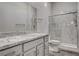 Modern bathroom featuring a spacious shower with glass doors and a vanity with granite countertops at 7095 Falabella Ridge Ave, Las Vegas, NV 89131