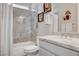 Bathroom features marble wall design, complemented by a marble-topped vanity, and white cabinets at 7095 Falabella Ridge Ave, Las Vegas, NV 89131
