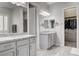 Elegant bathroom with dual sinks, granite countertops, walk-in closet, and shower at 7095 Falabella Ridge Ave, Las Vegas, NV 89131