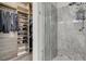 Bathroom featuring a walk-in closet and beautifully tiled walk-in shower at 7095 Falabella Ridge Ave, Las Vegas, NV 89131