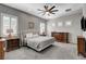 Large bedroom with ceiling fan, shutters and ornate wooden furniture at 7095 Falabella Ridge Ave, Las Vegas, NV 89131