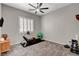 Bright exercise room offers a rower machine, free weights, and great natural light through window shutters at 7095 Falabella Ridge Ave, Las Vegas, NV 89131