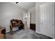 Bedroom with neutral walls, carpeted floors, with a wooden desk near the door at 7095 Falabella Ridge Ave, Las Vegas, NV 89131