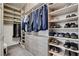 Walk-in closet with custom shelving, drawers, and ample storage space at 7095 Falabella Ridge Ave, Las Vegas, NV 89131