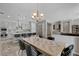 Elegant dining room with modern chandelier, stylish chairs, views of the kitchen, and an open layout for entertaining at 7095 Falabella Ridge Ave, Las Vegas, NV 89131