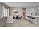 Open-concept design shows the dining area, kitchen island with bar stools, and sliding doors to the backyard at 7095 Falabella Ridge Ave, Las Vegas, NV 89131
