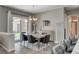 Bright dining area with sliding doors to the backyard, complemented by stylish decor and comfortable seating at 7095 Falabella Ridge Ave, Las Vegas, NV 89131