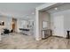 Inviting foyer featuring wood-look tile flooring and an open layout with views of the kitchen and dining area at 7095 Falabella Ridge Ave, Las Vegas, NV 89131