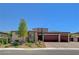 Charming single-story home boasting a three-car garage, stone accents, and meticulously landscaped front yard at 7095 Falabella Ridge Ave, Las Vegas, NV 89131