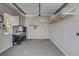Well-lit garage interior with storage cabinets, workbench, and epoxy floors at 7095 Falabella Ridge Ave, Las Vegas, NV 89131