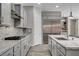 Modern kitchen featuring gray cabinetry, stainless steel appliances, a gas cooktop, and a large center island with a sink at 7095 Falabella Ridge Ave, Las Vegas, NV 89131