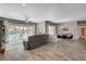 Open-concept living area featuring modern tile floors, a dining set, and sliding glass doors to the pool at 7095 Falabella Ridge Ave, Las Vegas, NV 89131