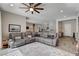 Spacious living room with a comfortable gray sectional sofa and an open layout at 7095 Falabella Ridge Ave, Las Vegas, NV 89131
