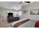 Relaxing main bedroom showcasing a comfortable seating area and a large television at 7095 Falabella Ridge Ave, Las Vegas, NV 89131