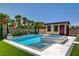 Backyard featuring a pool, spa, green lawn, cabana, and tropical landscaping at 7095 Falabella Ridge Ave, Las Vegas, NV 89131