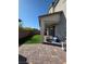 Beautiful backyard area featuring artificial grass, a paved patio, and privacy wall at 7114 Superstar St, North Las Vegas, NV 89084