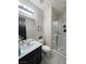 Bright bathroom featuring a shower with glass doors and a modern vanity with ample counter space at 7114 Superstar St, North Las Vegas, NV 89084