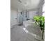 Bright bathroom featuring a glass shower and soaking tub near to a window and hanging plant at 7114 Superstar St, North Las Vegas, NV 89084