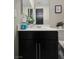 Bathroom featuring a black vanity cabinet, modern sink, and decorative mirror with a clean design at 7114 Superstar St, North Las Vegas, NV 89084