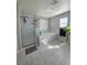 Bright bathroom featuring a glass shower and soaking tub near to a window and hanging plant at 7114 Superstar St, North Las Vegas, NV 89084