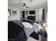 Bedroom with ceiling fan, large rug, TV and attached bathroom with soaking tub at 7114 Superstar St, North Las Vegas, NV 89084