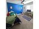 bedroom with blue accent wall and cozy decor at 7114 Superstar St, North Las Vegas, NV 89084