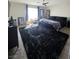 Spacious bedroom featuring a large rug, ceiling fan and ample natural light from the window at 7114 Superstar St, North Las Vegas, NV 89084