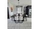 Open-concept dining area with a large table, stylish lighting, and modern decor at 7114 Superstar St, North Las Vegas, NV 89084