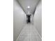 Bright, tiled hallway leading to the front door and other areas of the home at 7114 Superstar St, North Las Vegas, NV 89084