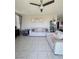 Cozy living room featuring neutral-toned sofas, tile flooring, and a modern ceiling fan at 7114 Superstar St, North Las Vegas, NV 89084