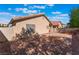 Backyard features low-maintenance desert landscaping with brick patio, perfect for enjoying outdoor living at 7116 Wonderberry St, Las Vegas, NV 89131