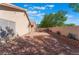 Desert-landscaped backyard featuring a decorative rock feature and a brick patio seating area at 7116 Wonderberry St, Las Vegas, NV 89131