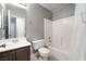 Neutral-colored bathroom featuring a single sink, toilet, and a bathtub/shower combo at 7116 Wonderberry St, Las Vegas, NV 89131