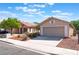 Charming single-story home with a two-car garage, complemented by desert landscaping and a driveway at 7116 Wonderberry St, Las Vegas, NV 89131