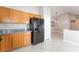 Bright kitchen featuring wood cabinets and black refrigerator at 7116 Wonderberry St, Las Vegas, NV 89131