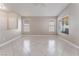 Bright living room featuring tile floors, neutral colors, and large windows at 7116 Wonderberry St, Las Vegas, NV 89131