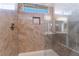 Shower stall featuring tile walls, glass enclosure, with showerhead and niche at 7116 Wonderberry St, Las Vegas, NV 89131