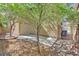Charming backyard featuring a patio and gravel landscaping beneath leafy trees at 7173 Las Colinas Ave, Las Vegas, NV 89179