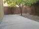 Backyard with gravel and brick lined plant beds, tall block wall and concrete patio at 7173 Las Colinas Ave, Las Vegas, NV 89179
