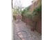 Backyard with gravel and brick lined plant beds, brick pathway and tall block wall at 7173 Las Colinas Ave, Las Vegas, NV 89179