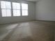 Bright, carpeted bedroom with large windows at 7173 Las Colinas Ave, Las Vegas, NV 89179
