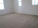 Bright, carpeted bedroom featuring multiple windows at 7173 Las Colinas Ave, Las Vegas, NV 89179