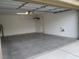 Spacious garage with cement floors, overhead storage, and a closed garage door at 7173 Las Colinas Ave, Las Vegas, NV 89179