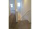 Hallway with carpeted floors leading to a window and stairs to the basement at 7173 Las Colinas Ave, Las Vegas, NV 89179