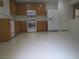 Well lit kitchen with a white refrigerator and tan cabinets at 7173 Las Colinas Ave, Las Vegas, NV 89179