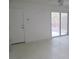 Living room with white walls, linoleum floors, sliding glass door to the backyard and front door at 7173 Las Colinas Ave, Las Vegas, NV 89179