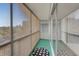 Enclosed balcony with green carpet, sliding glass doors, and views of the city skyline at 725 N Royal Crest Cir # 246, Las Vegas, NV 89169