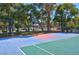 Community basketball court featuring a colorful playing surface, and chain-link fence surrounded by mature trees at 725 N Royal Crest Cir # 246, Las Vegas, NV 89169