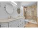 Bathroom with a double sink vanity, large mirrors, and a tile surround walk-in shower at 725 N Royal Crest Cir # 246, Las Vegas, NV 89169